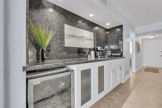 a kitchen with stainless steel appliances granite countertop a sink a stove and cabinets