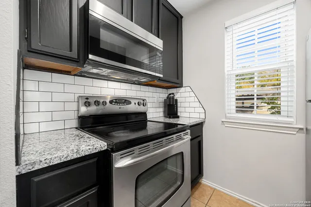 a stove top oven sitting inside of a kitchen