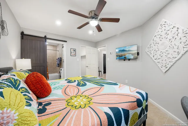 a bedroom with a bed and ceiling fan