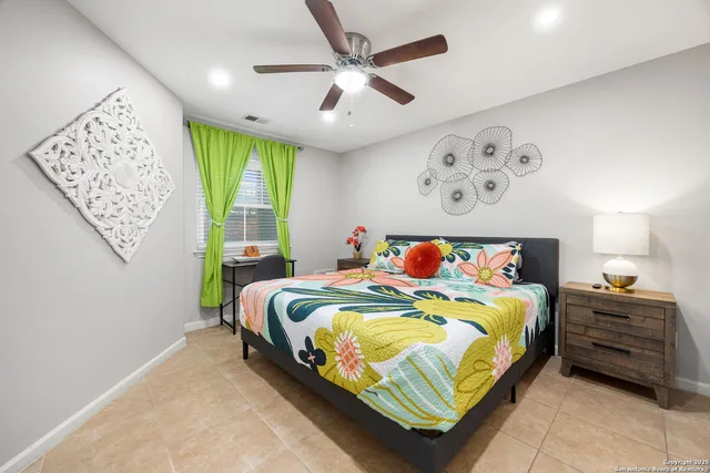 a bedroom with a bed and a large window