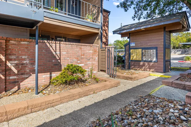 a view of a house with a patio and a yard