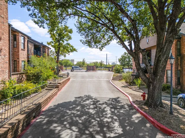 a street sign on a sidewalk next to a road