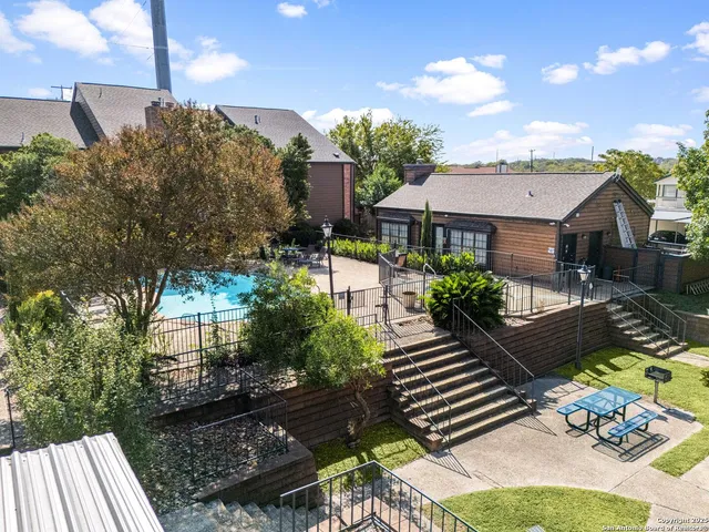 an aerial view of a house with a garden and a yard
