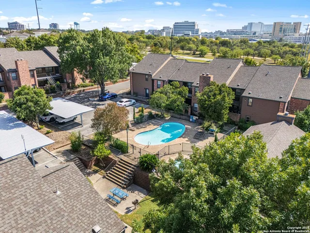 an aerial view of residential house with outdoor space and swimming pool
