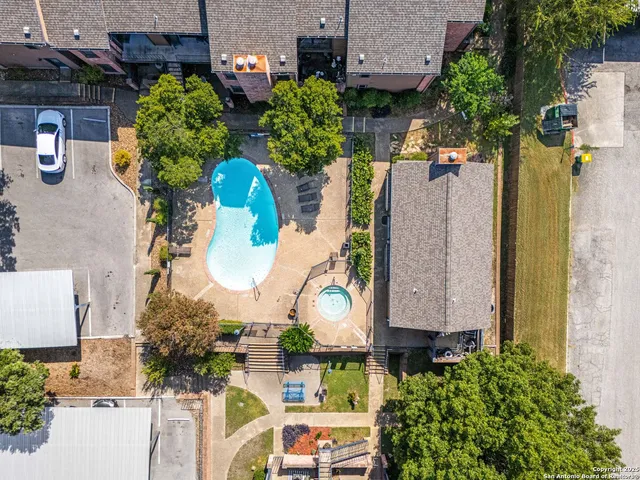 an aerial view of residential houses with outdoor space