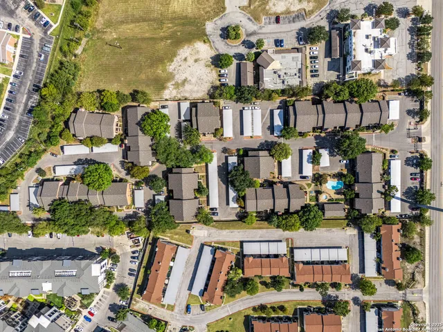 an aerial view of multiple houses with yard