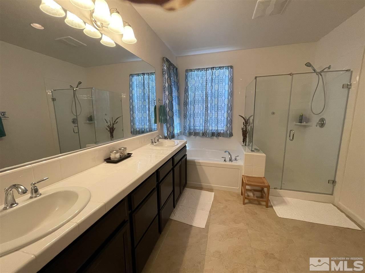 2165 Hope Valley Drive Reno, NV 89521 - Photo 14 of 22 a bathroom with a sink double vanity granite tub shower and mirror