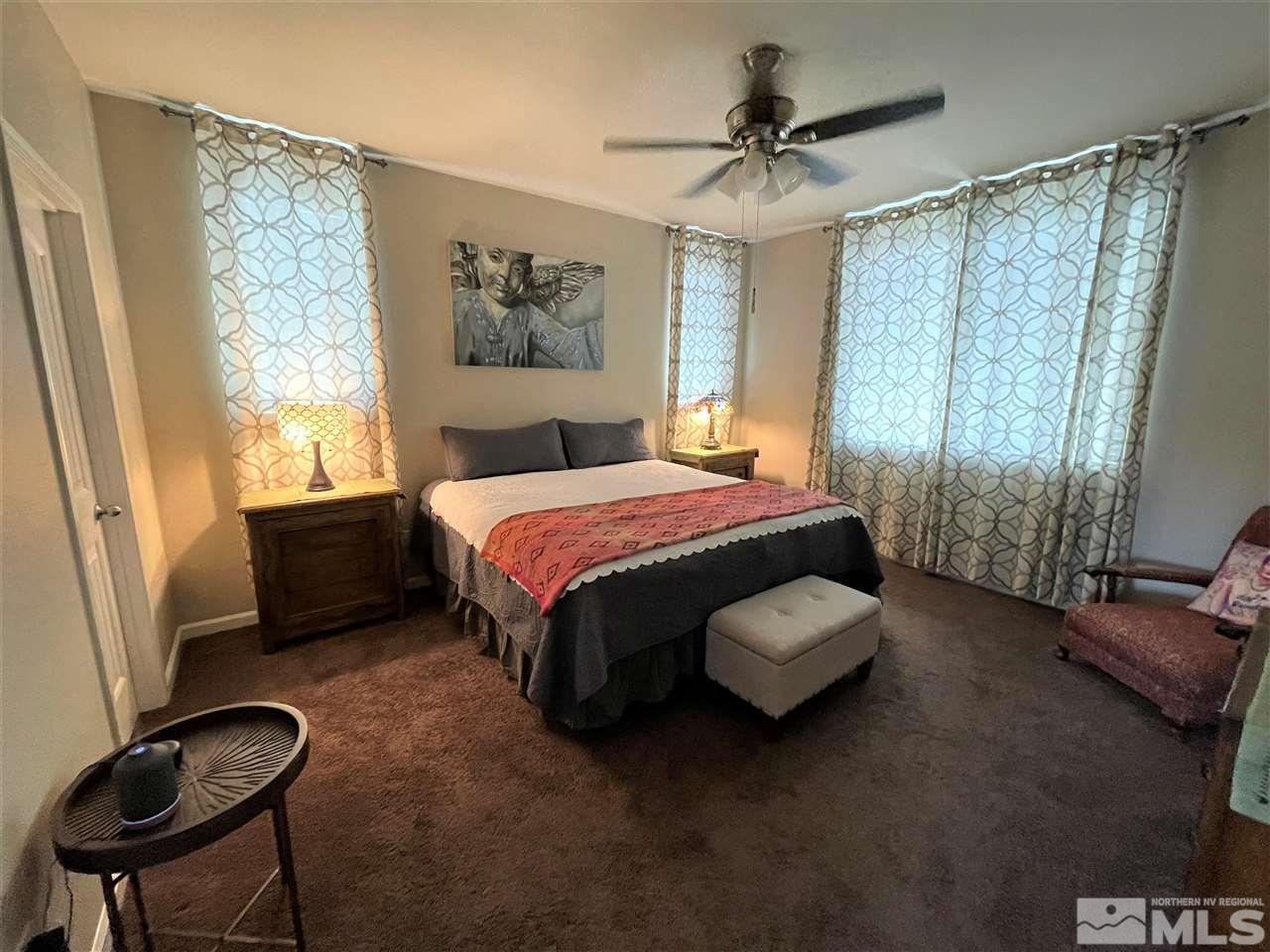 2165 Hope Valley Drive Reno, NV 89521 - Photo 16 of 22 a bedroom with a bed and a chair