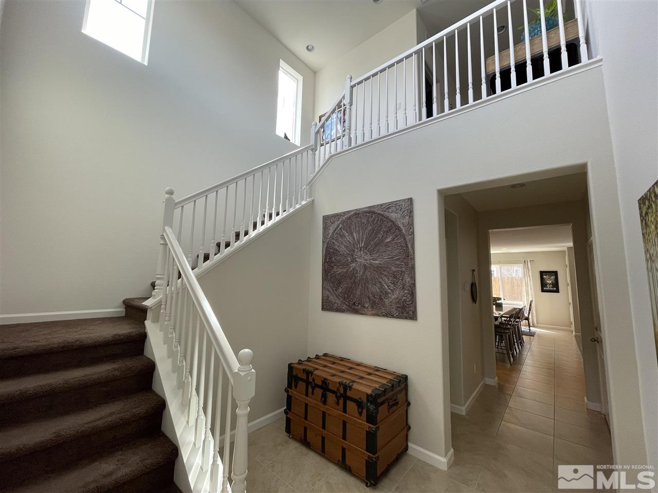 2165 Hope Valley Drive Reno, NV 89521 - Photo 2 of 22 a view of staircase with lots of frames on wall and a chandelier