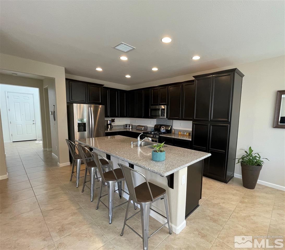 2165 Hope Valley Drive Reno, NV 89521 - Photo 3 of 22 a kitchen with a table chairs and a refrigerator