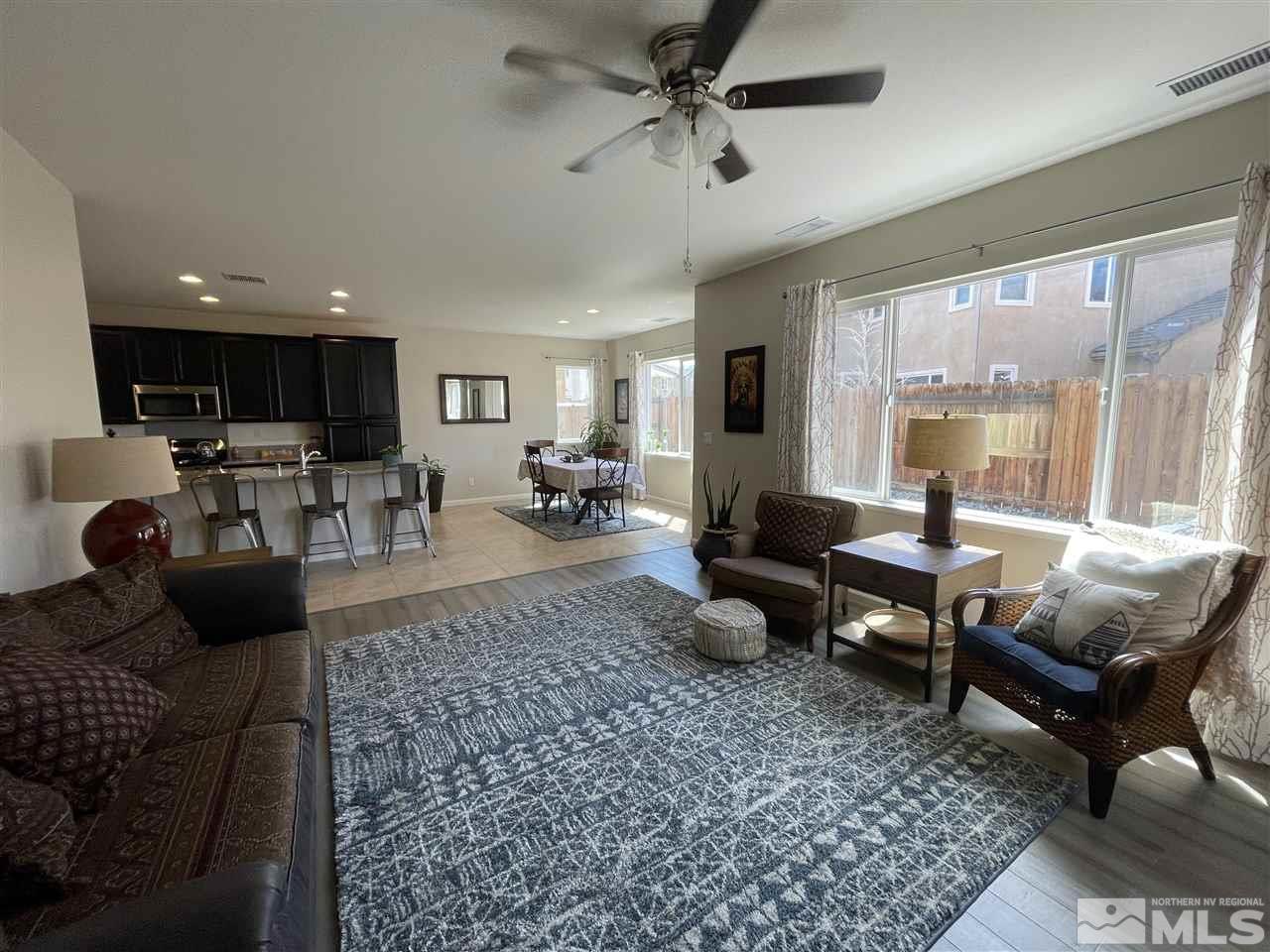 2165 Hope Valley Drive Reno, NV 89521 - Photo 8 of 22 a living room with furniture a rug and a large window