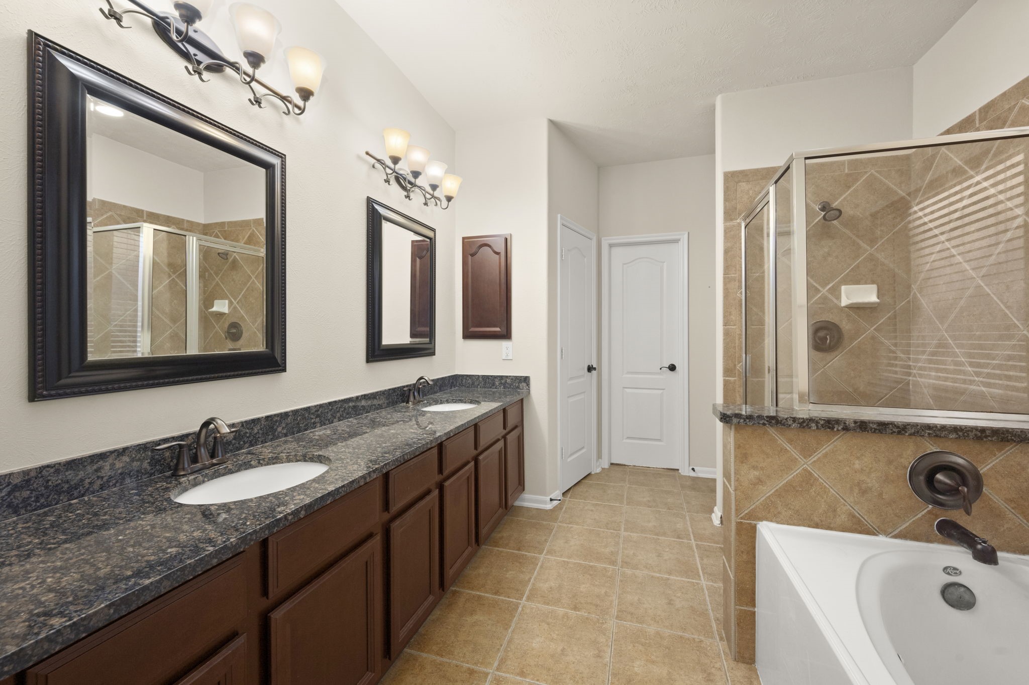 17411 Rainer Valley Lane Humble, TX 77346 - Photo 12 of 21 a bathroom with a granite countertop sink double vanity and a mirror