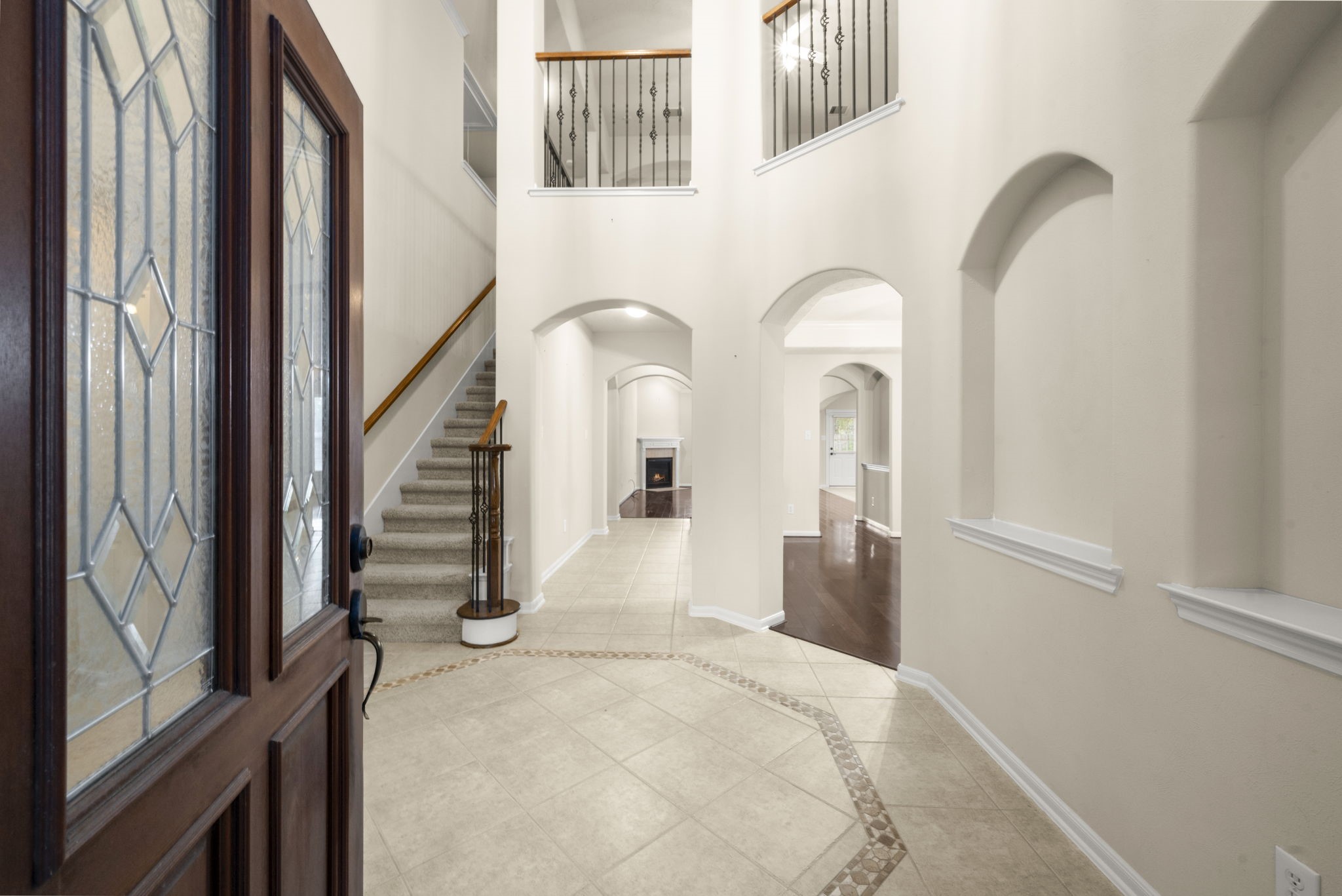 17411 Rainer Valley Lane Humble, TX 77346 - Photo 3 of 21 a view of a hallway with wooden floor and staircase