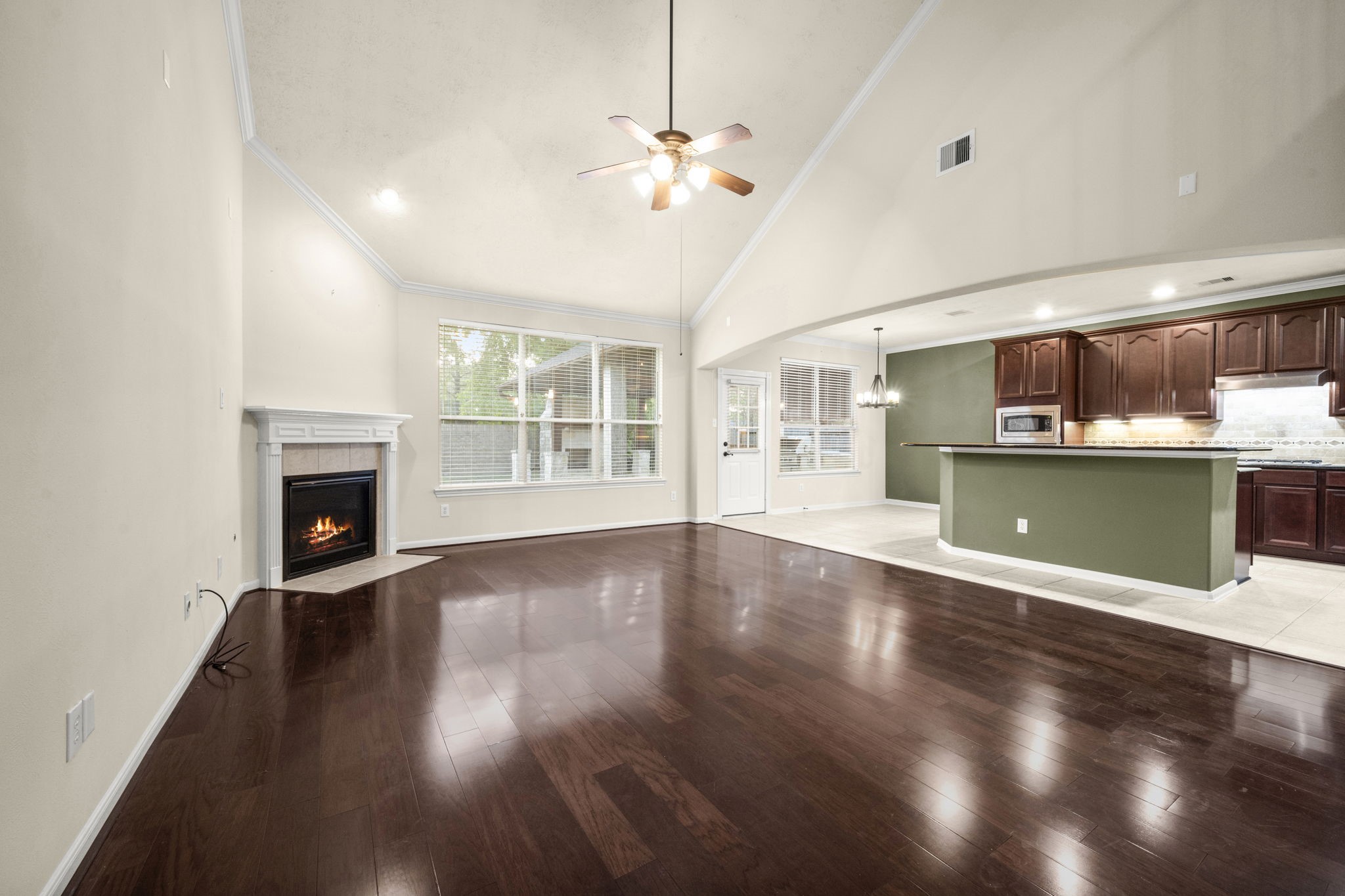 17411 Rainer Valley Lane Humble, TX 77346 - Photo 6 of 21 a view of a room with wooden floor and a fireplace
