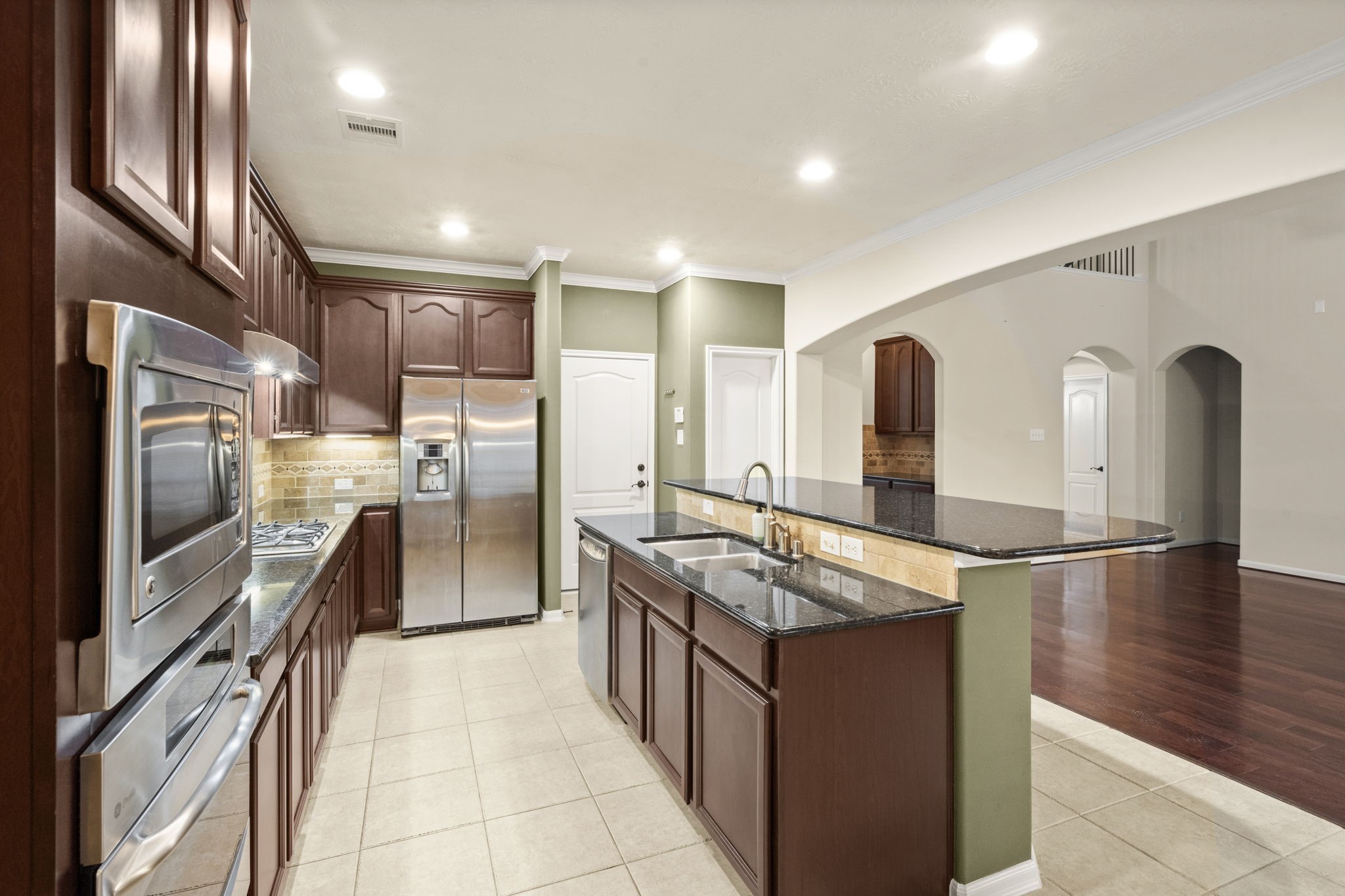 17411 Rainer Valley Lane Humble, TX 77346 - Photo 9 of 21 a kitchen with stainless steel appliances granite countertop a refrigerator and a stove