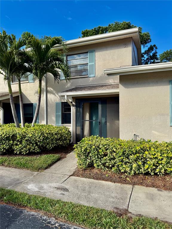 2131 Ridge Road South, Unit 105 Largo, FL 33778 - Photo 1 of 20 a front view of a house with a garden