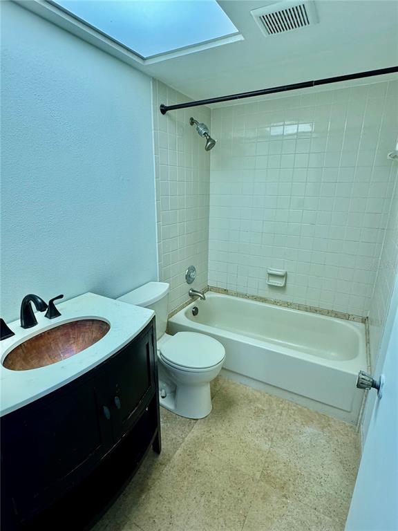 2131 Ridge Road South, Unit 105 Largo, FL 33778 - Photo 13 of 20 a bathroom with a sink a toilet and shower
