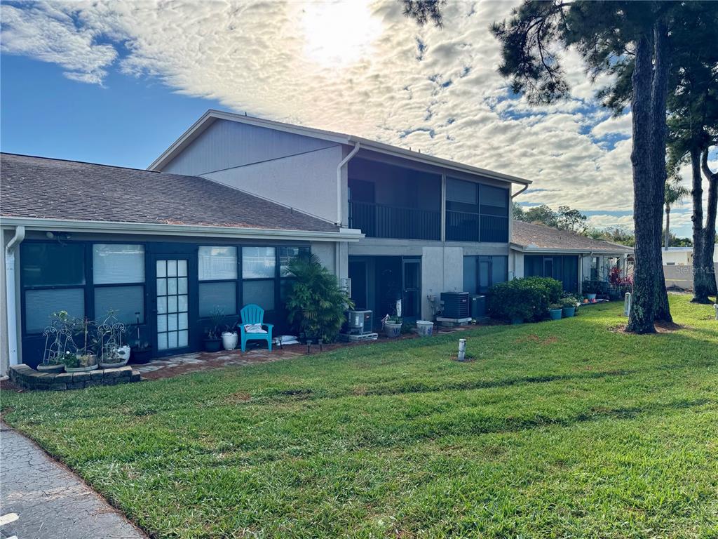 2131 Ridge Road South, Unit 105 Largo, FL 33778 - Photo 17 of 20 a front view of a house with a yard and porch