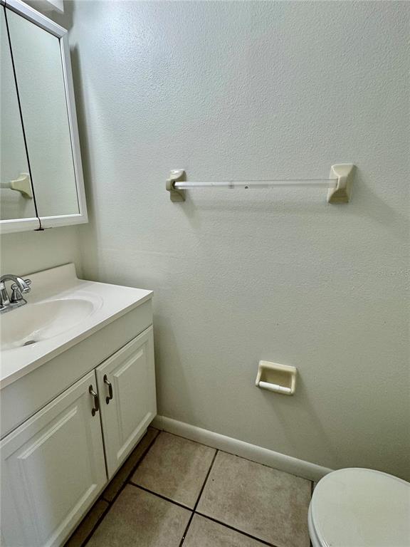 2131 Ridge Road South, Unit 105 Largo, FL 33778 - Photo 10 of 20 a bathroom with a sink a toilet and a mirror
