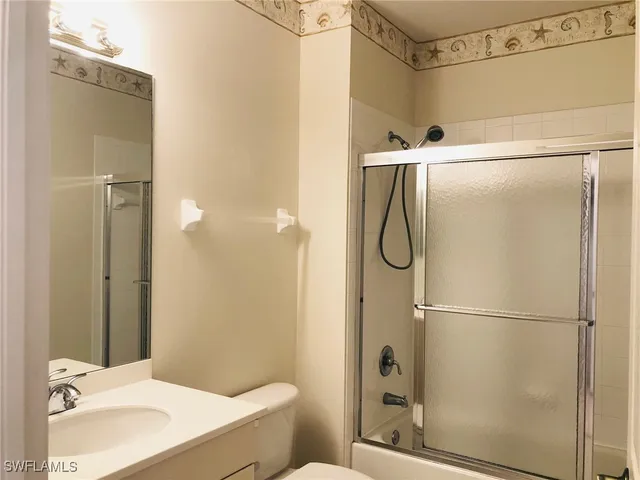 a bathroom with a shower and a sink