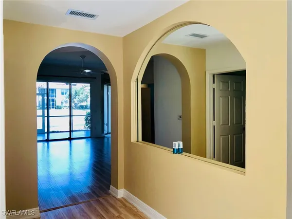 a view of an entryway door with wooden floor