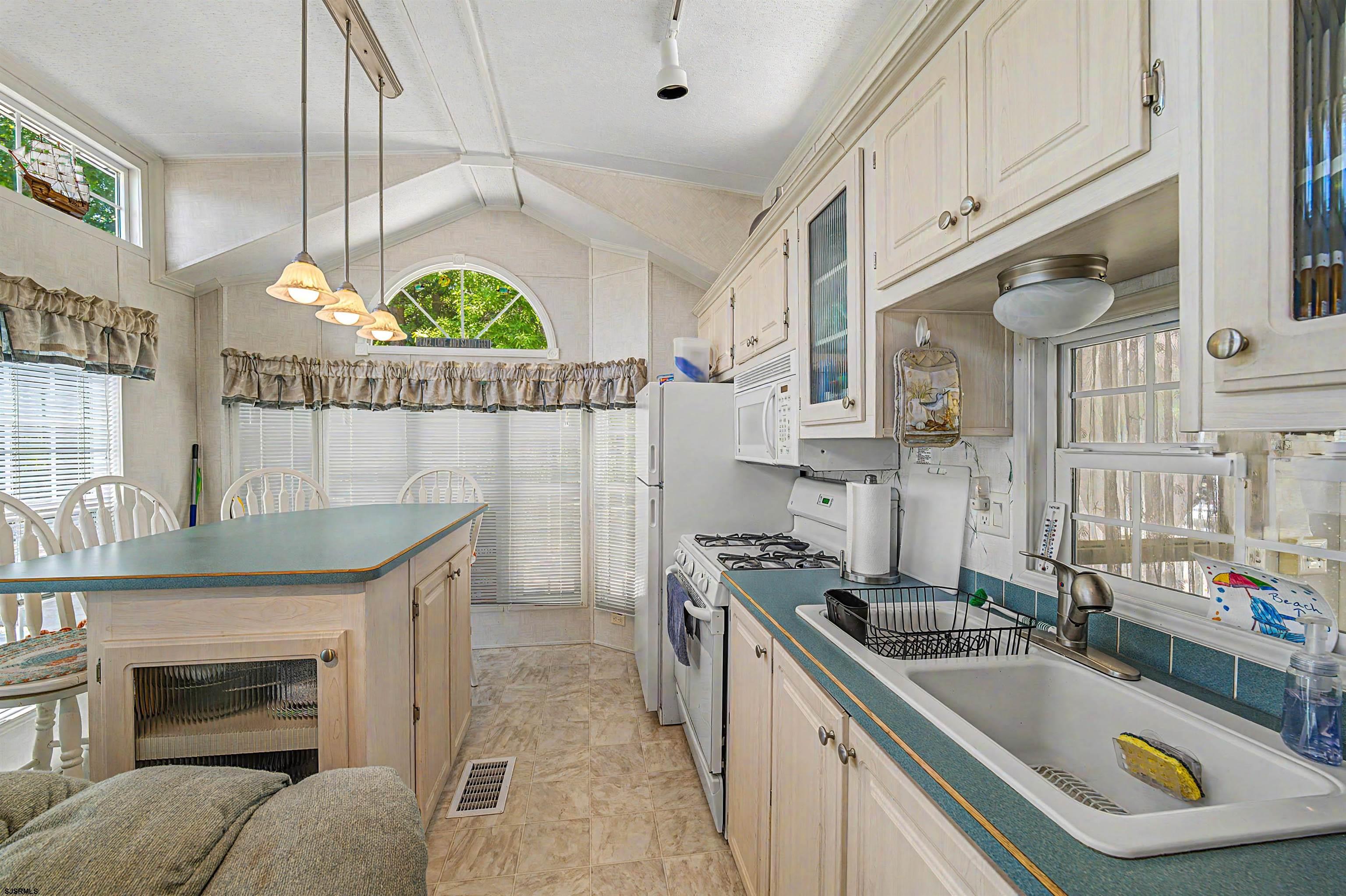 3066 Route 9 Ocean View, NJ 08230 - Photo 13 of 29 a kitchen that has a sink a stove and a wooden floor