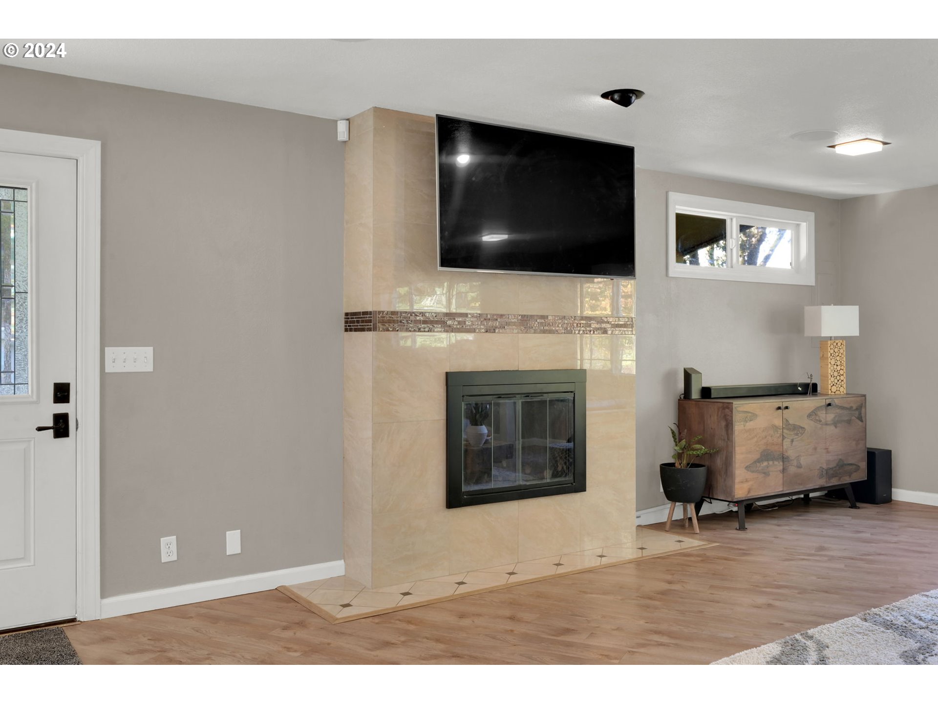 927 South 47th Street Springfield, OR 97478 - Photo 8 of 48 a living room with furniture a flat screen tv and a fireplace