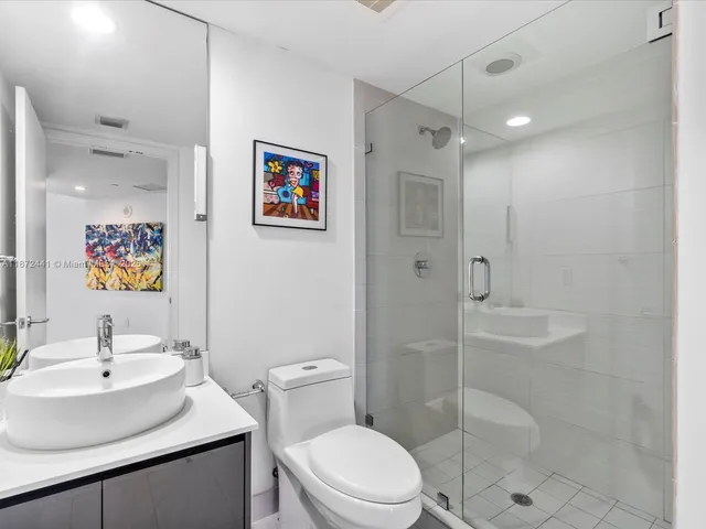 a bathroom with a sink toilet and shower