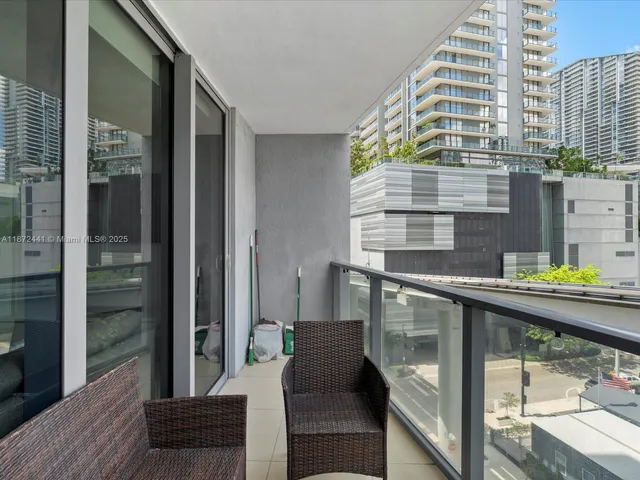 a couple of chairs sitting in a roof deck with outdoor seating
