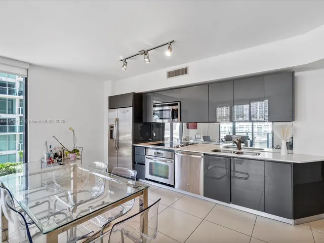 a kitchen with stainless steel appliances granite countertop a sink and cabinets