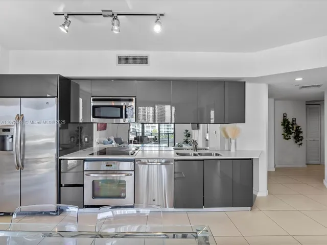 a kitchen with a sink and refrigerator