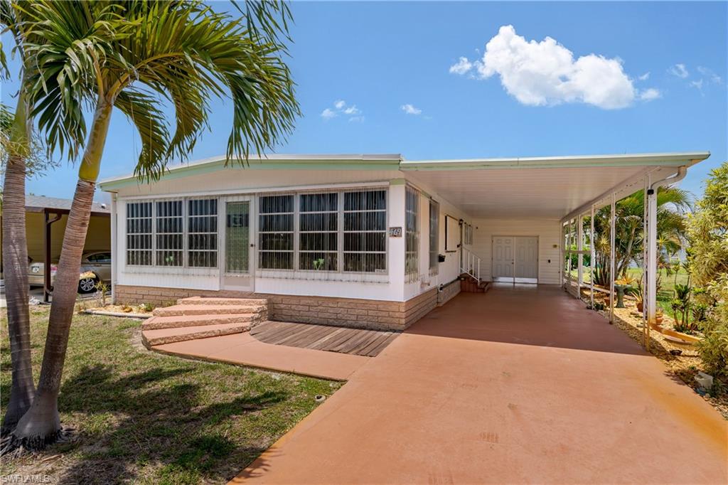 469 Riviera Boulevard West Naples, FL 34112 - Photo 20 of 31 Carport with Entry Doors to Shed
