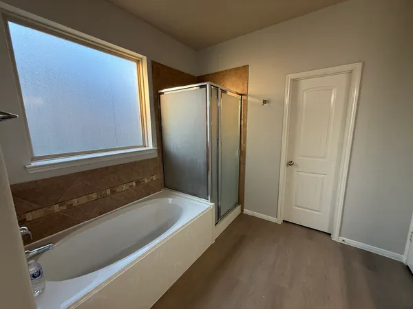 a bathroom with a bathtub and a shower