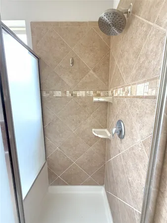 a bathroom with a glass shower door