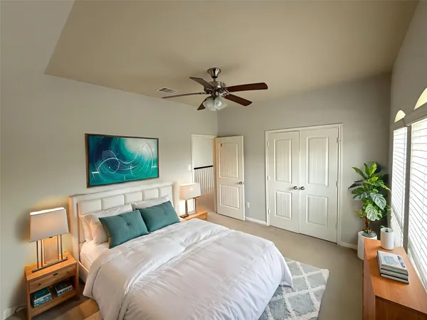 a bedroom with a bed and a chandelier