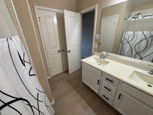 a bathroom with a sink a mirror and a shower