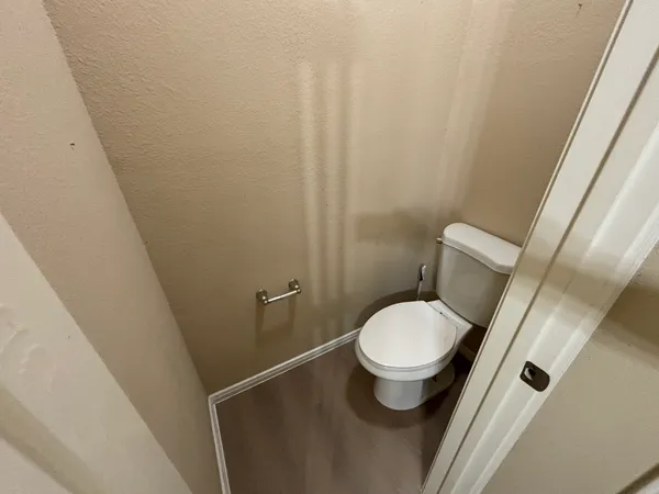 a white toilet sitting next to a small sink