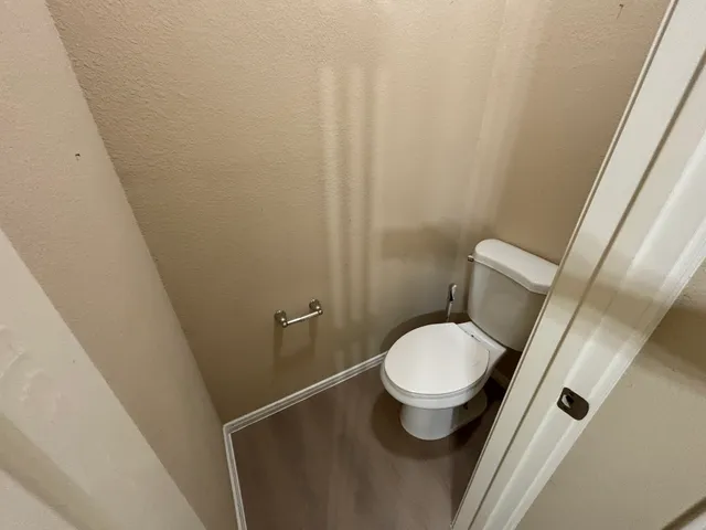 a white toilet sitting next to a small sink