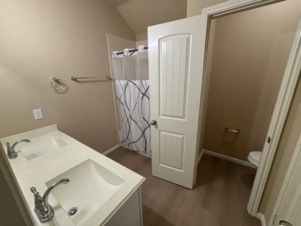 a bathroom with a sink and shower