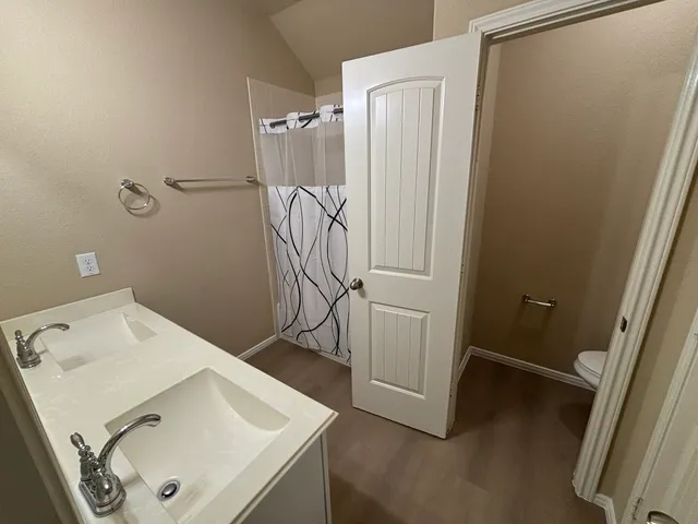 a bathroom with a sink and shower