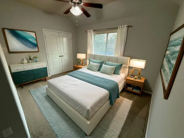 a bedroom with a bed and a chandelier