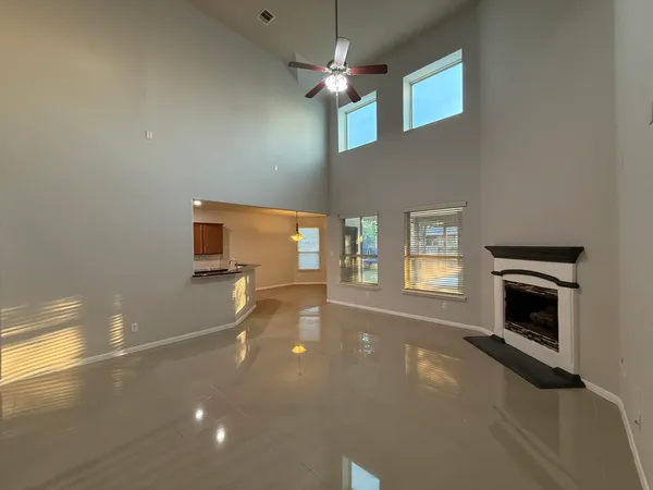 a living room with a fireplace furniture and a ceiling fan