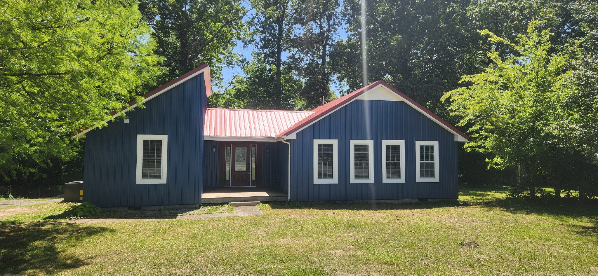 a view of a house with yard and tree s