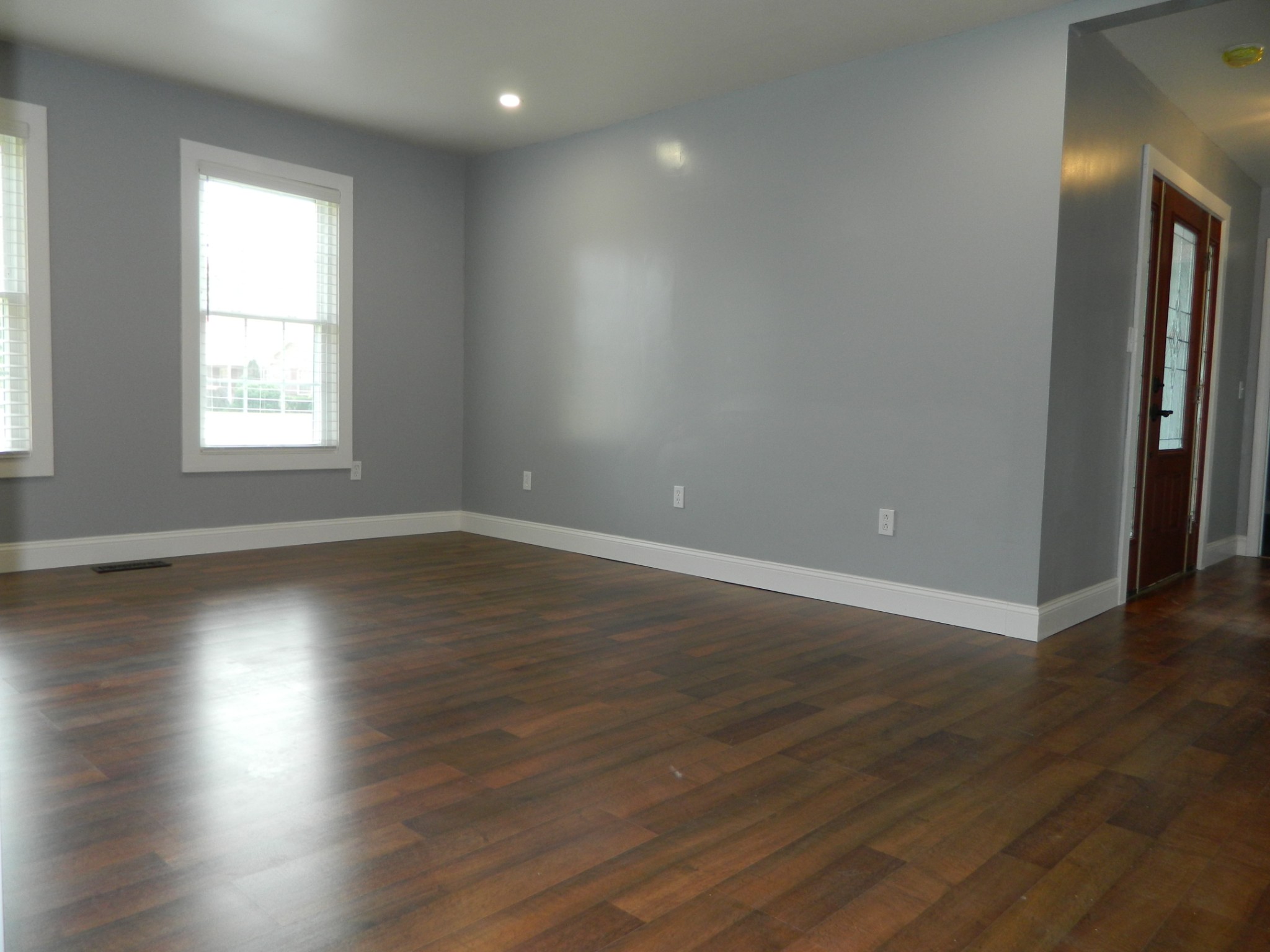 1276 Gip Manning Road Clarksville, TN 37042 - Photo 2 of 15 an empty room with wooden floor and windows with curtains