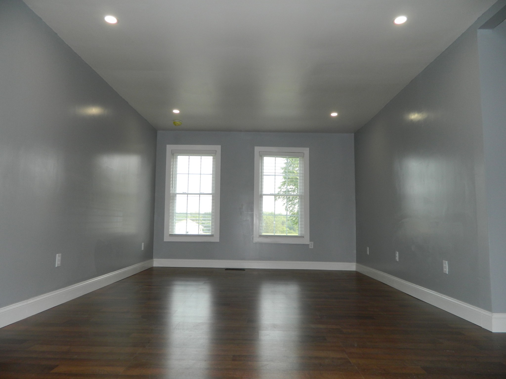 1276 Gip Manning Road Clarksville, TN 37042 - Photo 3 of 15 an empty room with wooden floor and windows with curtains