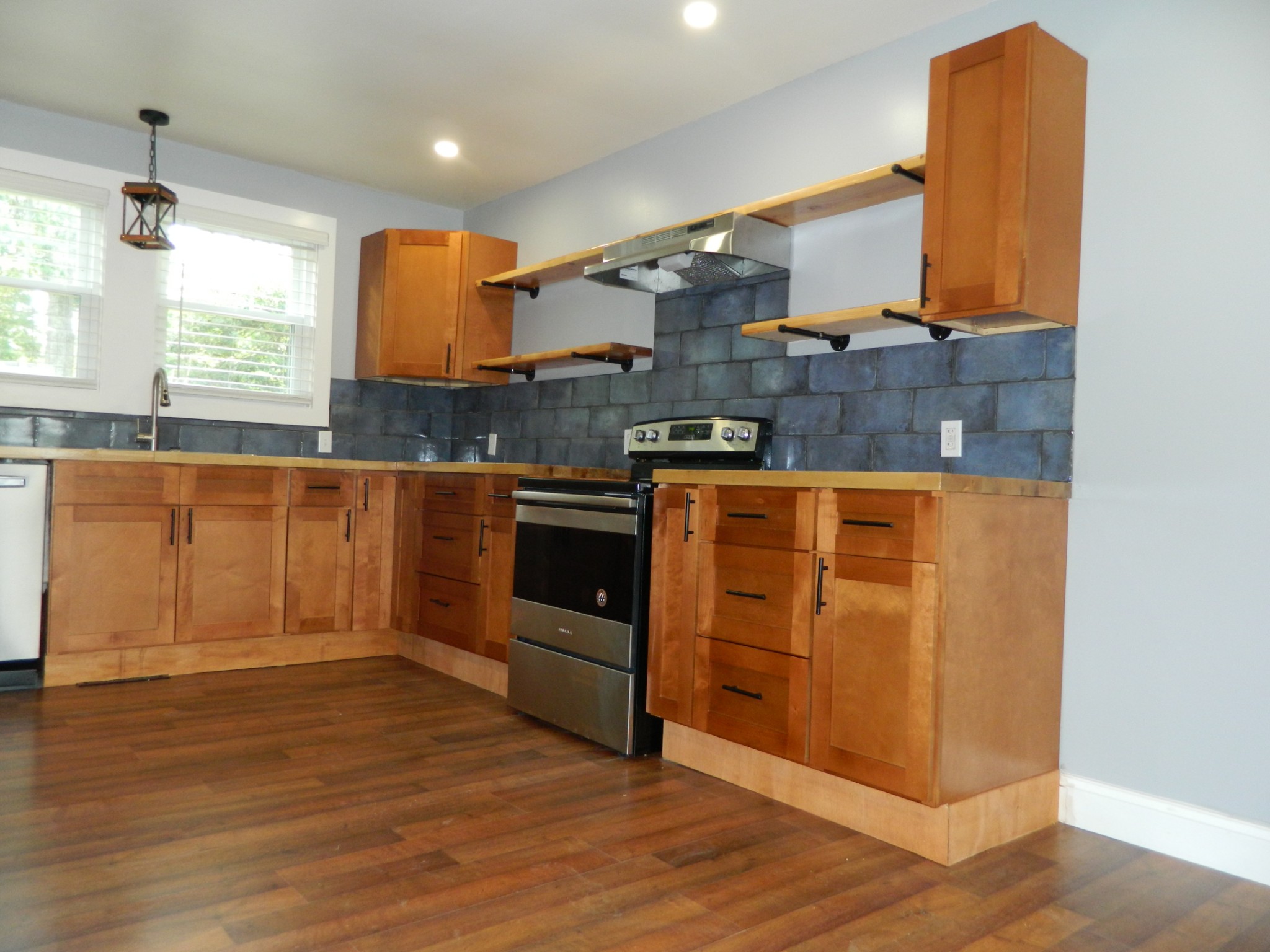 1276 Gip Manning Road Clarksville, TN 37042 - Photo 6 of 15 a kitchen with stainless steel appliances granite countertop a stove and a sink