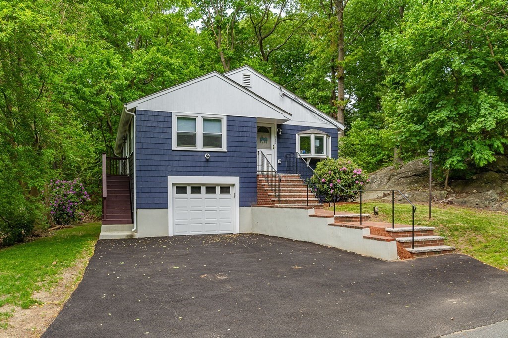155 Spring Street Stoneham, MA 02180 - Photo 3 of 30 a front view of a house with a yard and garage