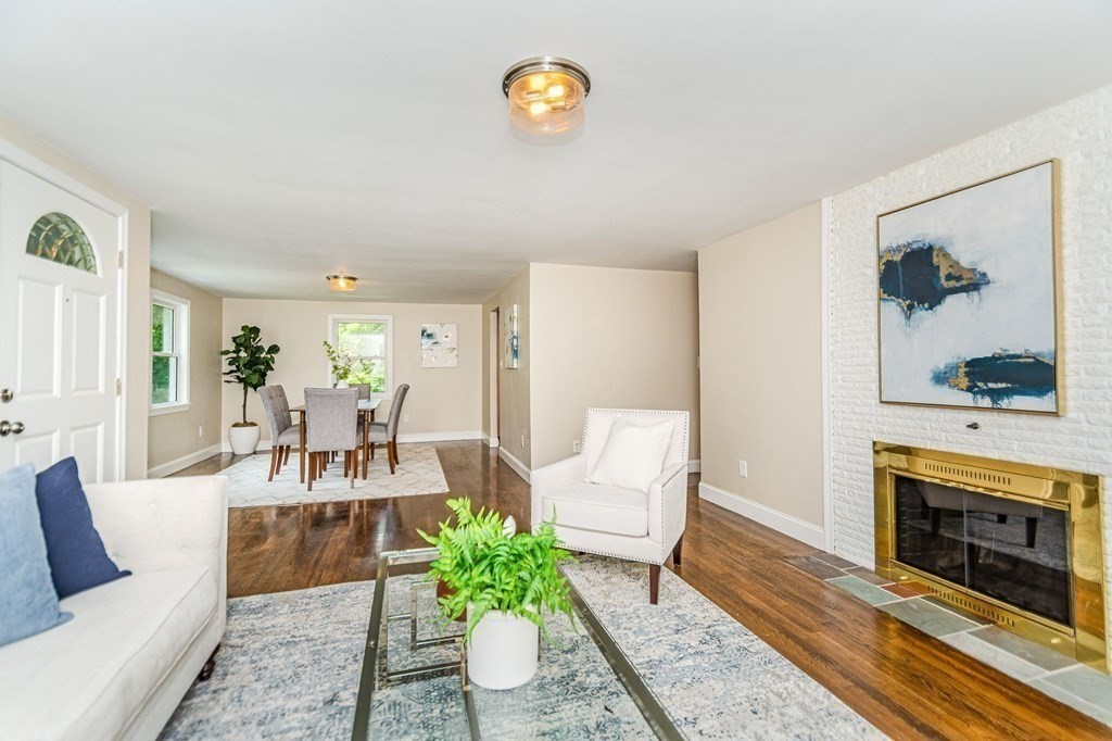 155 Spring Street Stoneham, MA 02180 - Photo 7 of 30 a living room with furniture and a fireplace