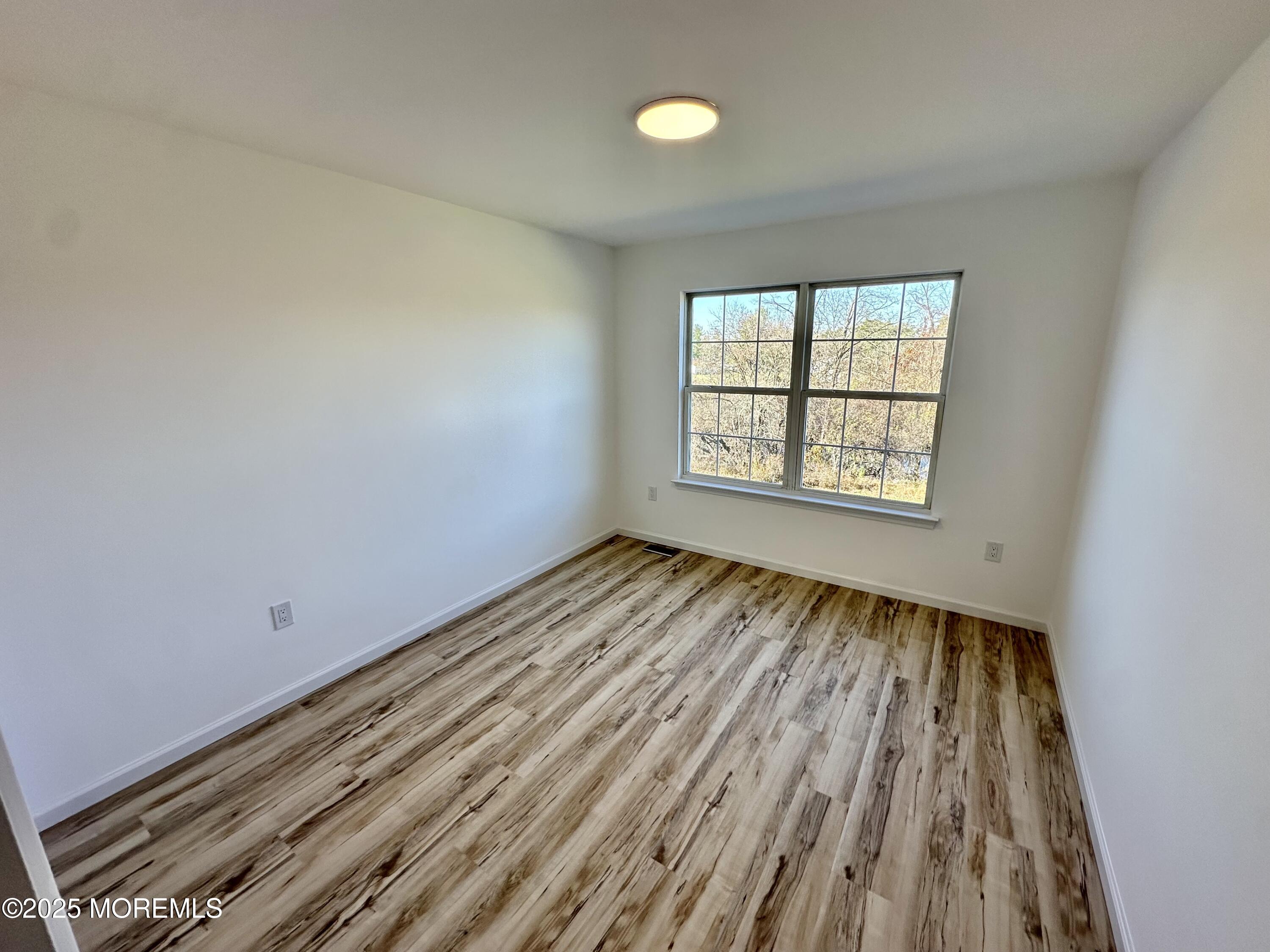 51 Picket Place Freehold, NJ 07728 - Photo 20 of 47 wooden floor in an empty room with a window