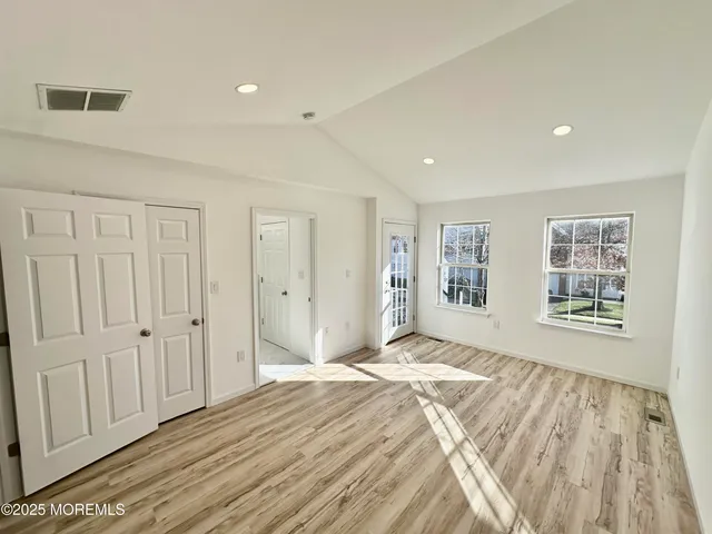 a spacious bedroom with a bed and a window